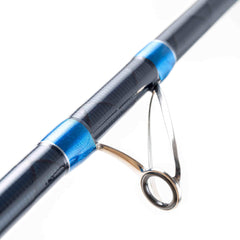 Close-up of Mojo Muscle X Power surfcasting rod guide with blue accents and carbon fiber texture